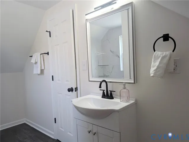 a bathroom with a sink and mirror