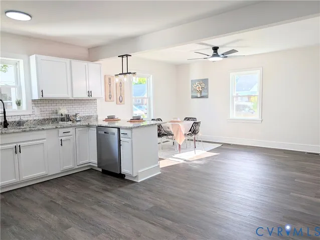 a kitchen with a sink cabinets and wooden floor