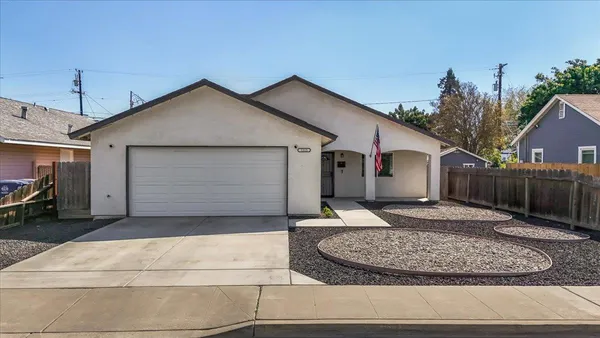 a front view of a house with trees