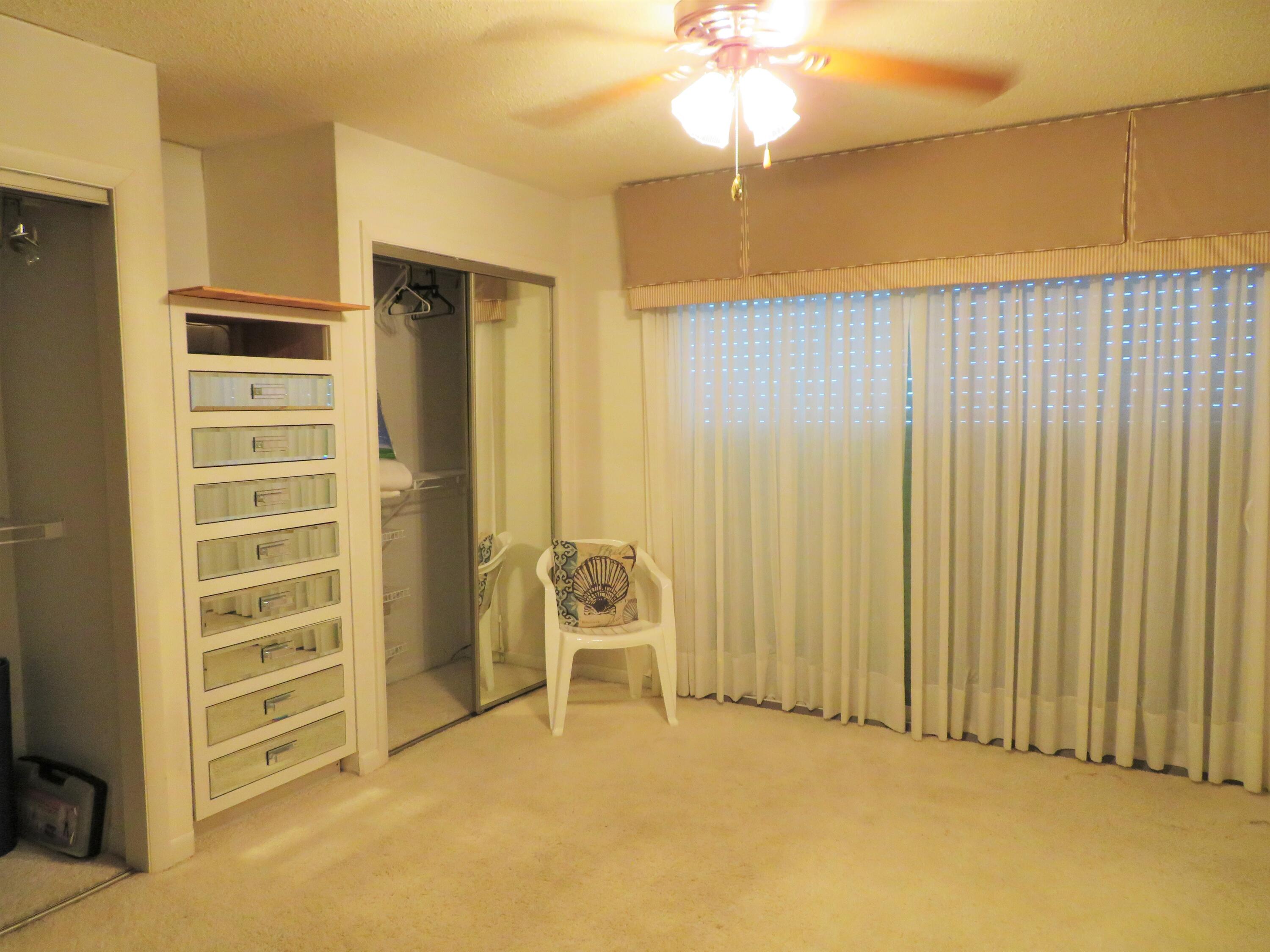 191 Durango Road Destin, FL 32541 - Photo 20 of 25 an empty room with chandelier fan and windows