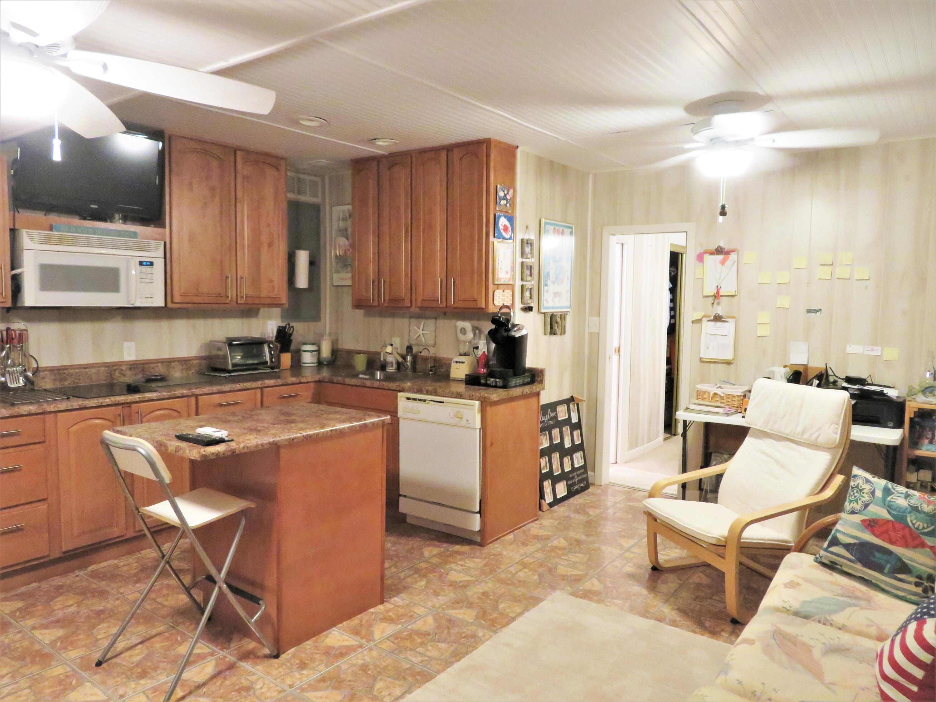 191 Durango Road Destin, FL 32541 - Photo 23 of 25 a living room with stainless steel appliances kitchen island granite countertop furniture and a counter top space