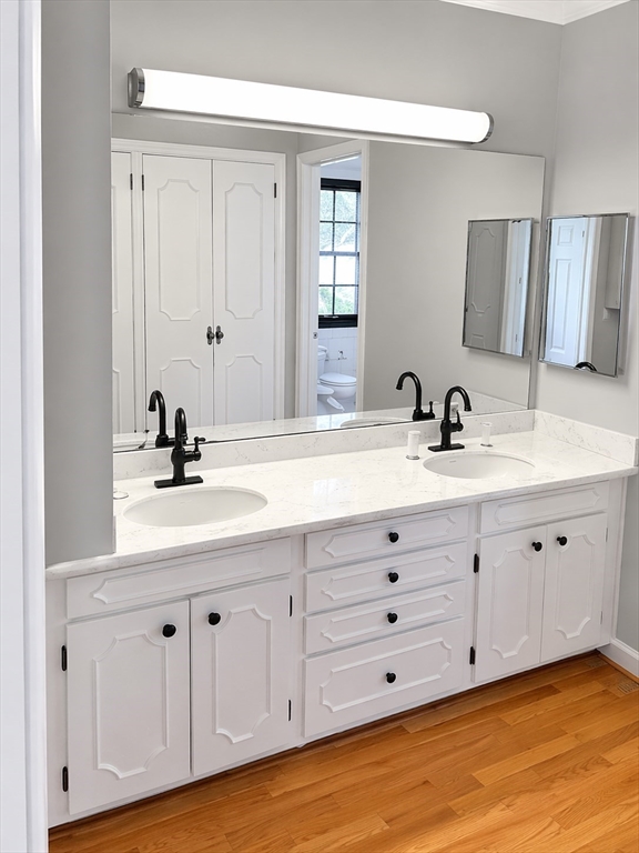 12 Woodland Road Westfield, MA 01085 - Photo 10 of 29 a bathroom with double vanity sink a mirror a lamp and vanity