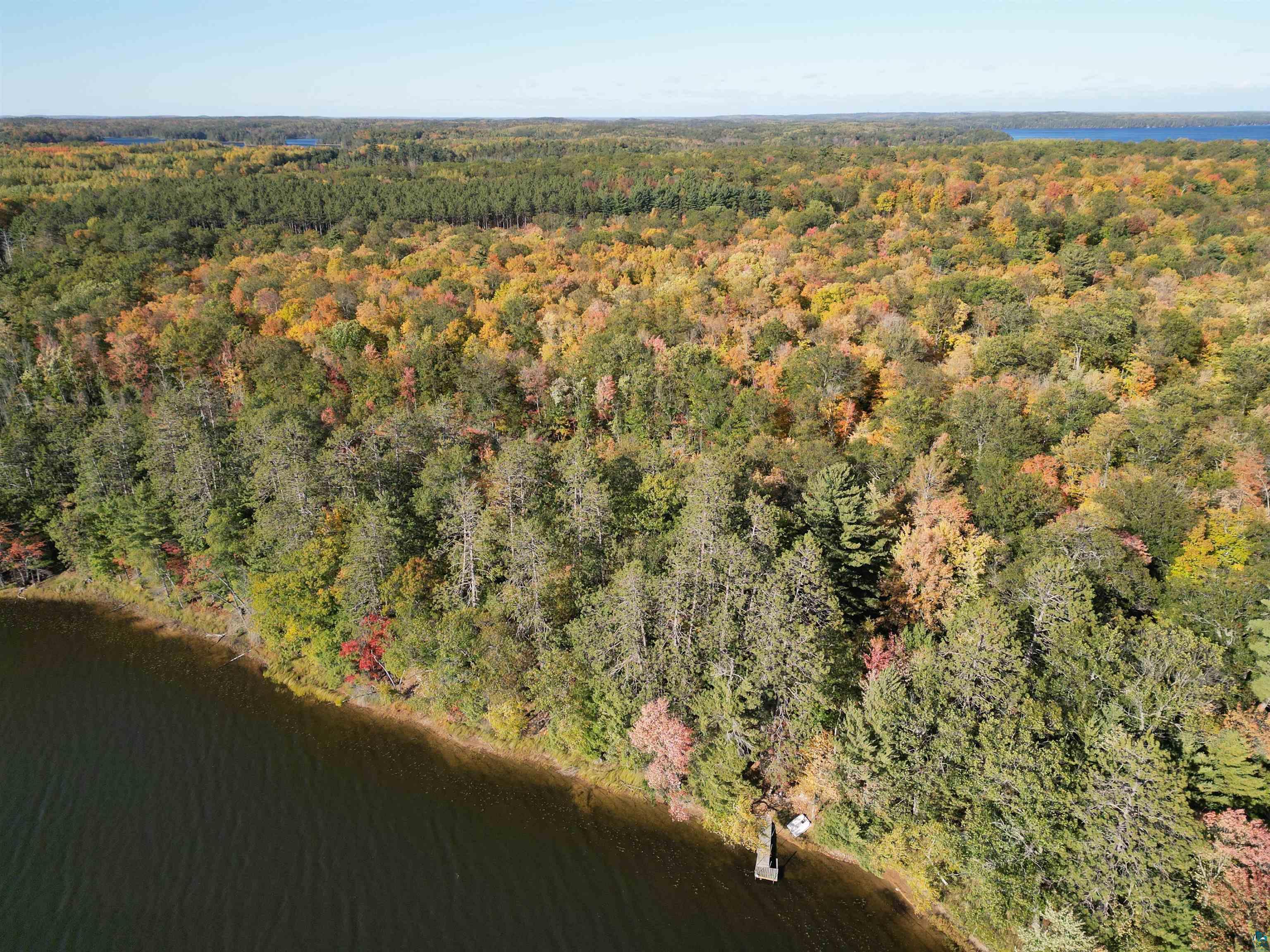 7621 White Beach Road Hayward, WI 54843 - Photo 16 of 26 View of property location featuring a heavily wooded area and a large body of water