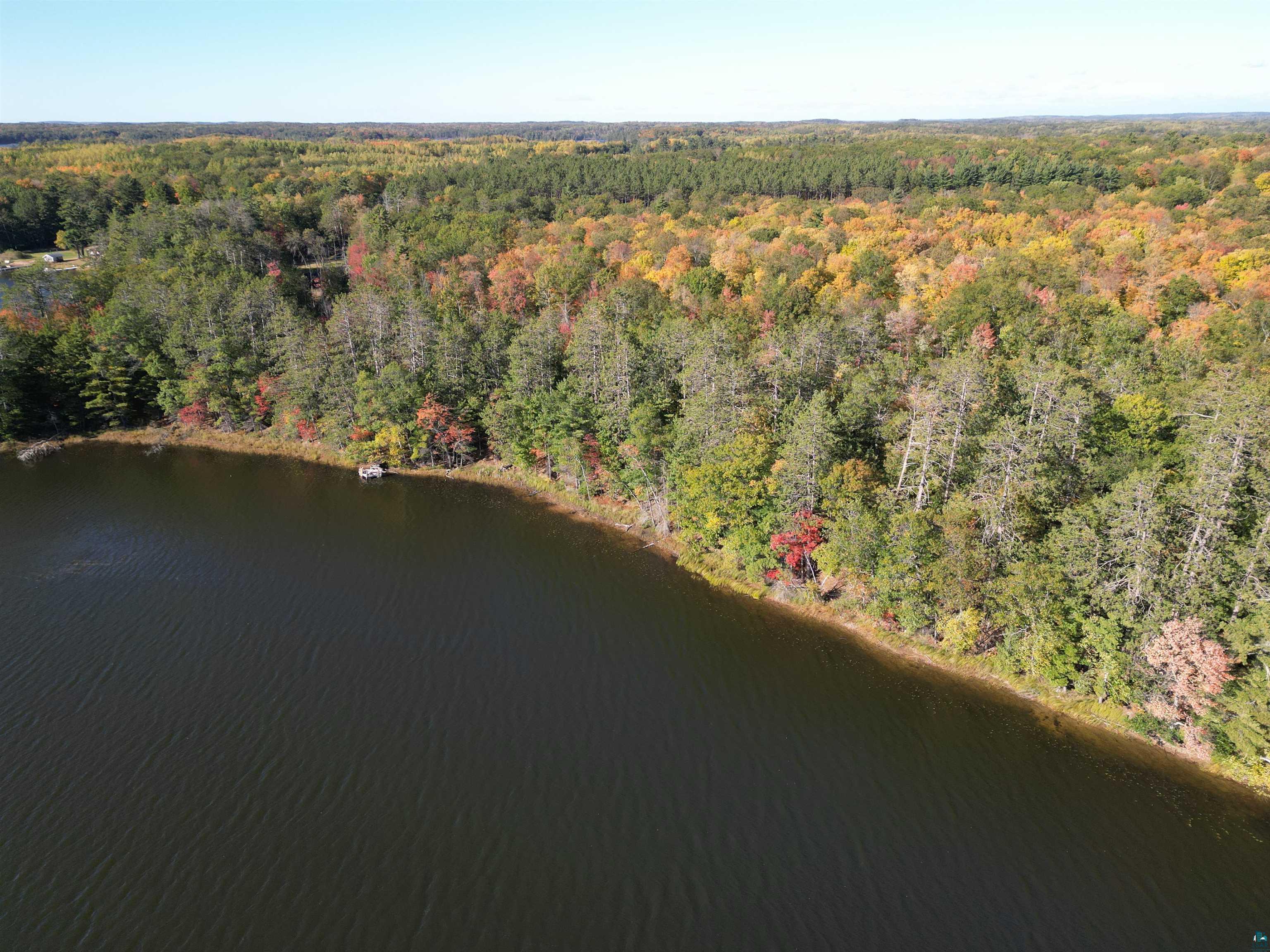 7621 White Beach Road Hayward, WI 54843 - Photo 20 of 26 Aerial view of property's location with a heavily wooded area and a large body of water