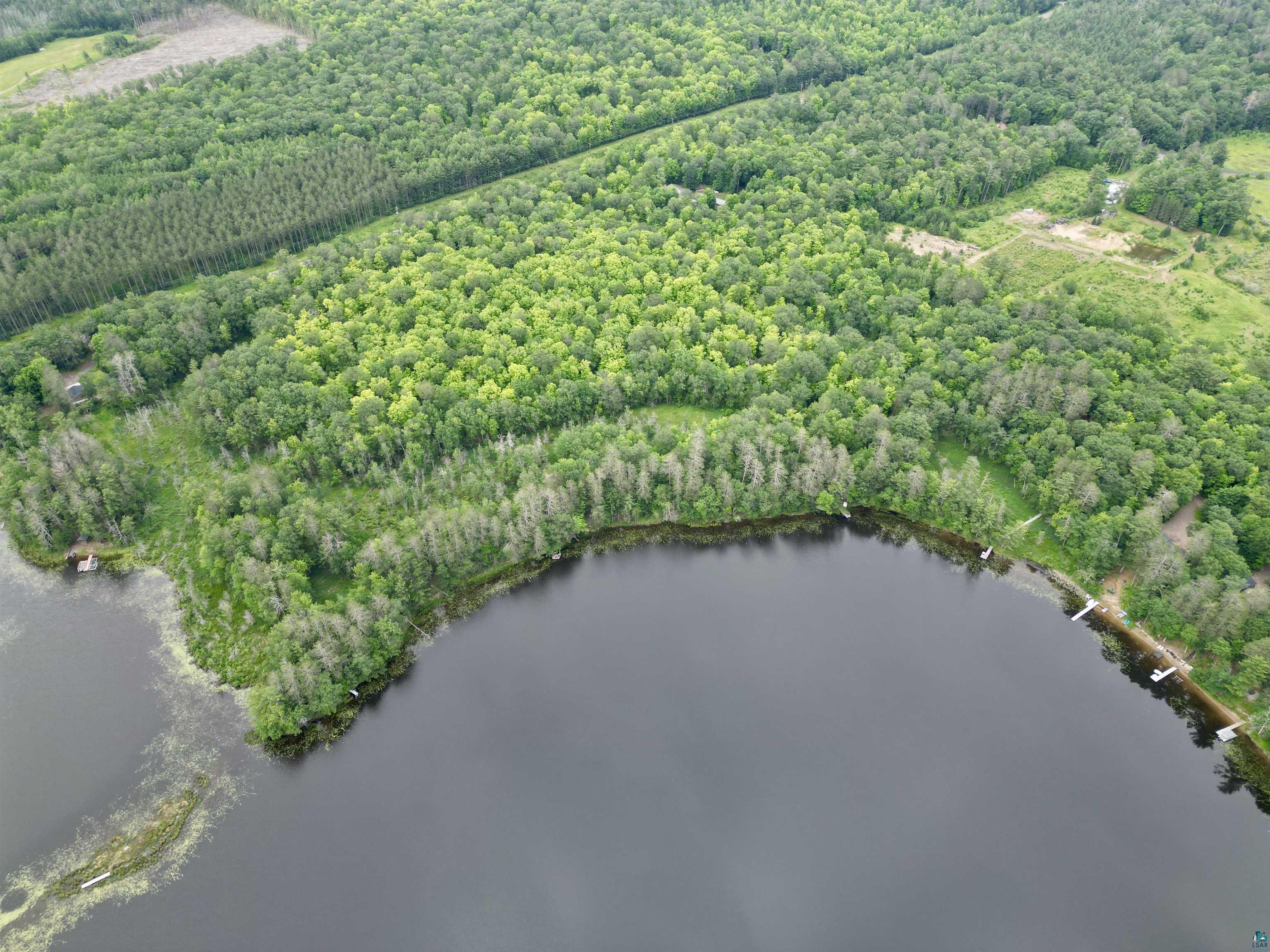 7621 White Beach Road Hayward, WI 54843 - Photo 5 of 26 Drone / aerial view of a large body of water and a heavily wooded area
