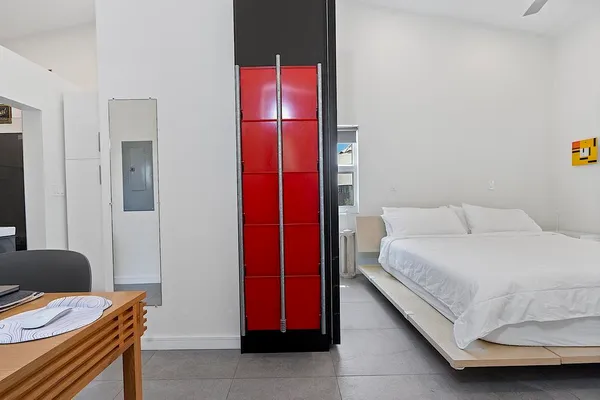 a bedroom with a bed and a chair