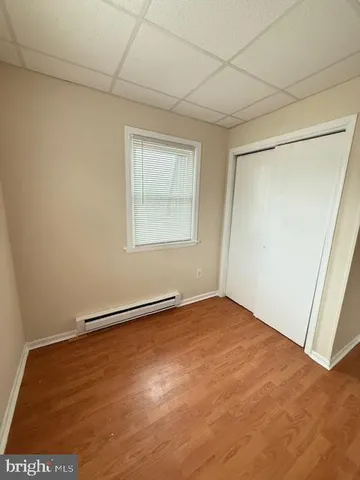 an empty room with windows and closet
