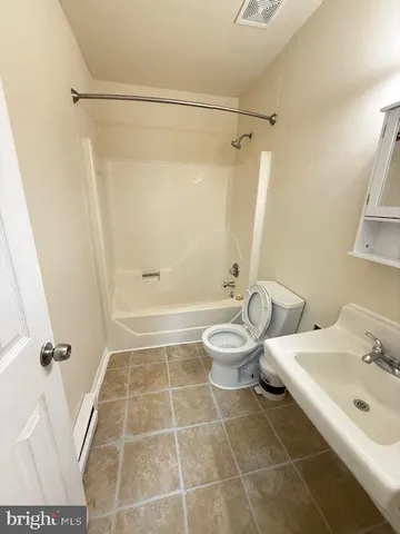 a bathroom with a double vanity sink toilet and shower
