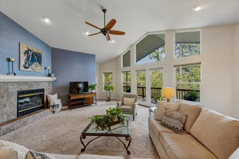 a view of a dining room and livingroom with furniture wooden floor a chandelier