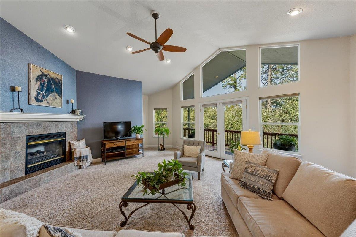 16041 John Way Grass Valley, CA 95949 - Photo 15 of 56 a living room with furniture a large window and a fireplace