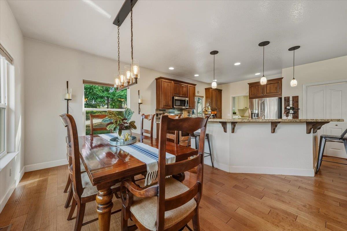 16041 John Way Grass Valley, CA 95949 - Photo 17 of 56 a view of a dining room and livingroom with furniture wooden floor a chandelier