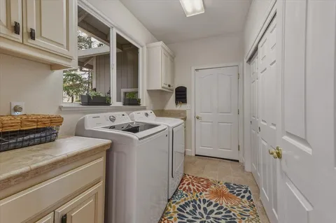 a bed sitting in a bedroom next to a window