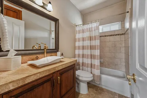 a bathroom with double vanity sinks and a mirror