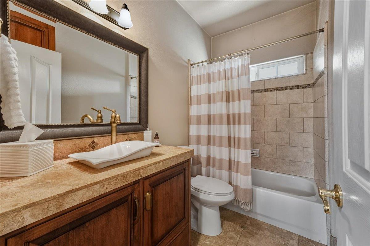 16041 John Way Grass Valley, CA 95949 - Photo 29 of 56 a bathroom with a granite countertop sink a toilet and shower