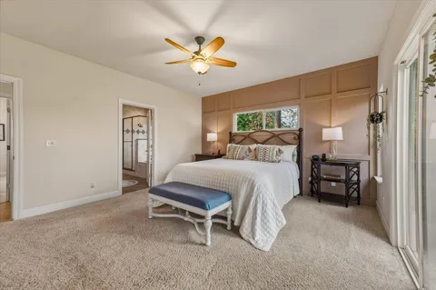 a spacious bathroom with a tub sink and mirror