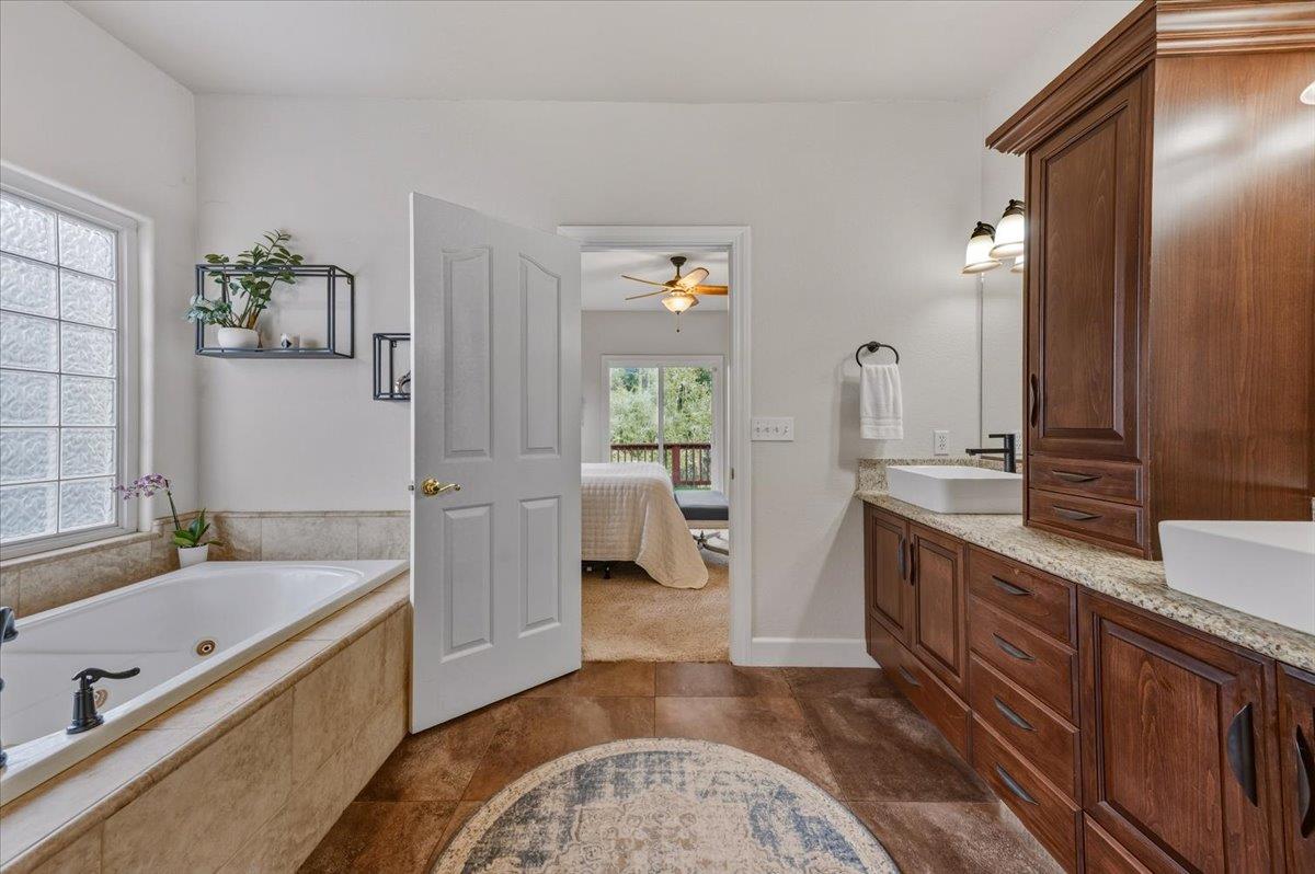 16041 John Way Grass Valley, CA 95949 - Photo 32 of 56 a spacious bathroom with a tub sink and mirror