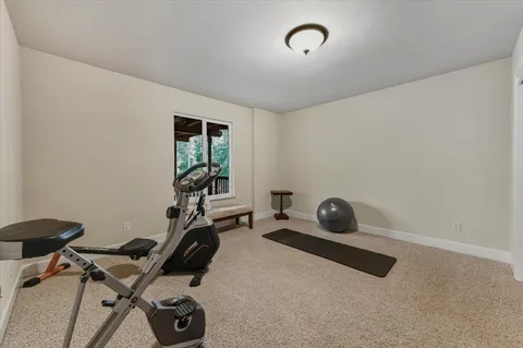 a large bed sitting in a bedroom next to a window