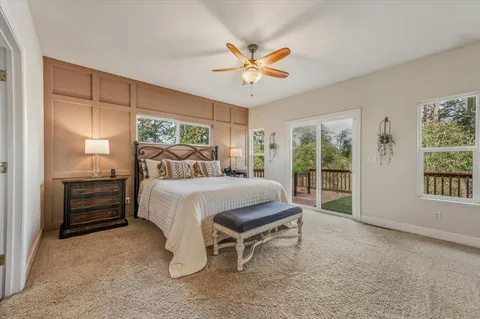 a white house covered with tall trees