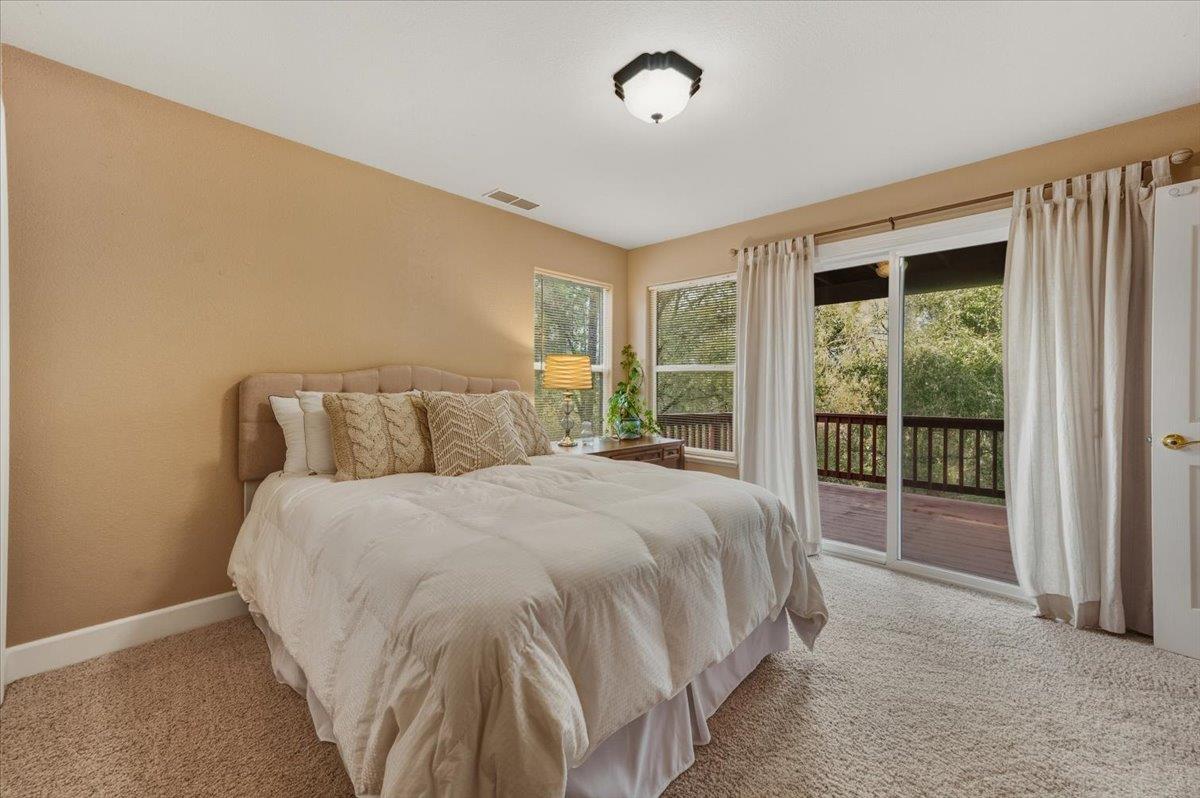 16041 John Way Grass Valley, CA 95949 - Photo 42 of 56 a large bed sitting in a bedroom next to a window