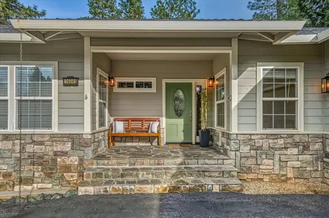 a view of a workspace with furniture and a potted plant