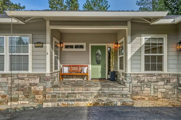 a view of a workspace with furniture and a potted plant