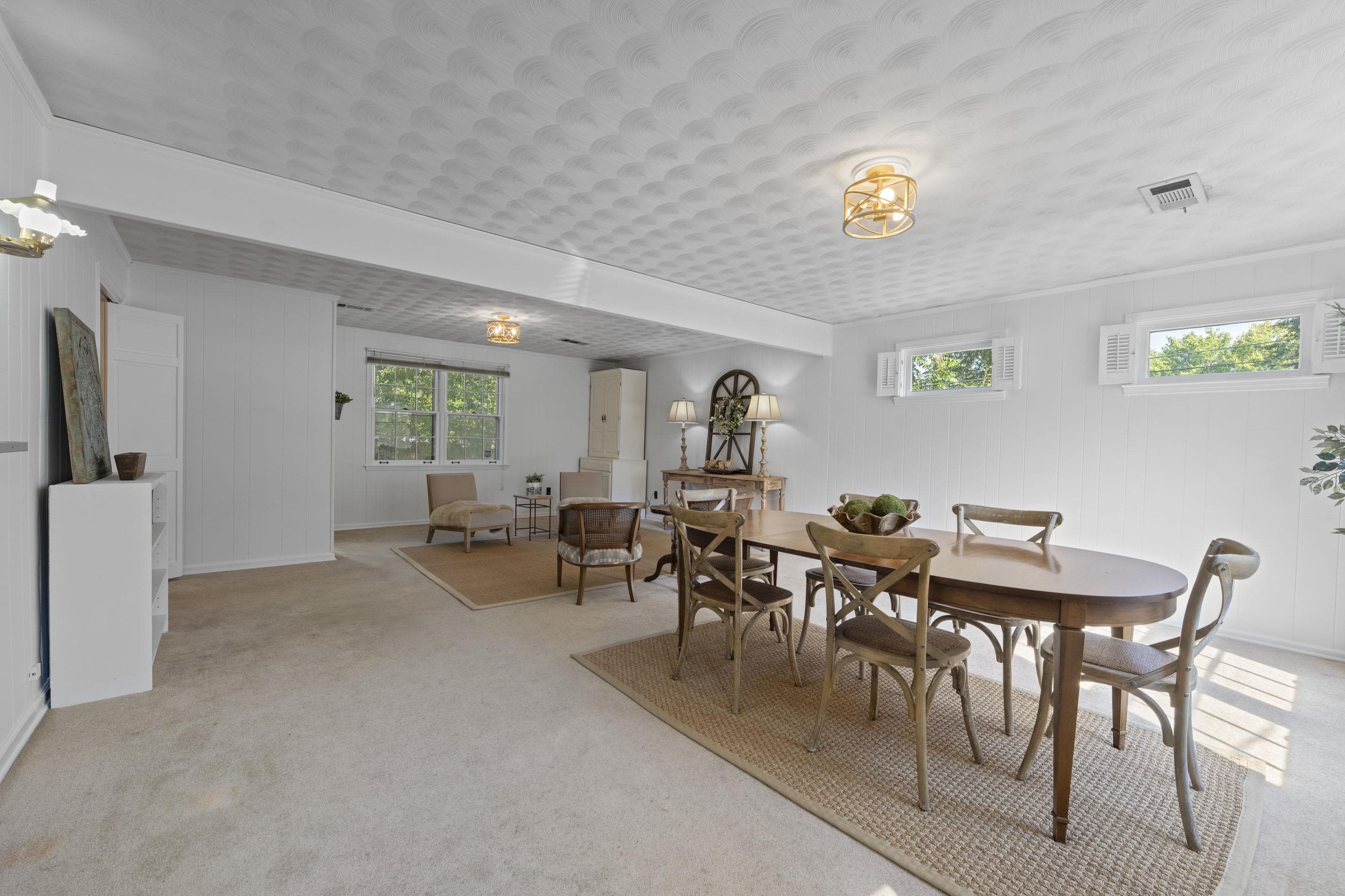 5076 Dee Road Memphis, TN 38117 - Photo 12 of 26 Designed for comfort, this rear great room blends casual charm with spacious proportions, easily accommodating both dining and lounging — a true heart-of-the-home retreat.