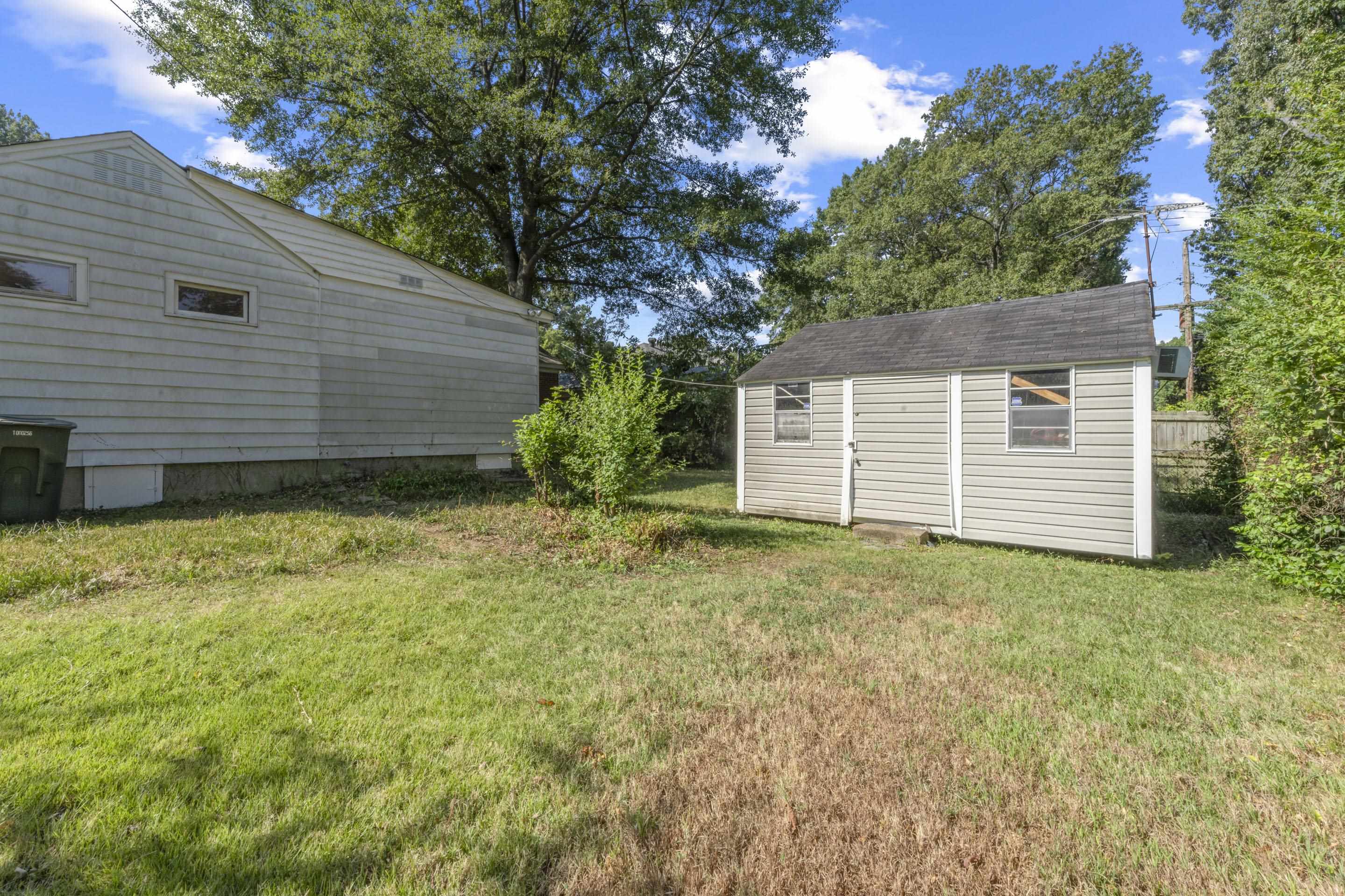 5076 Dee Road Memphis, TN 38117 - Photo 6 of 26 The backyard is more than just green space — it includes a wired workshop and a storage shed, giving you both storage and creativity space.