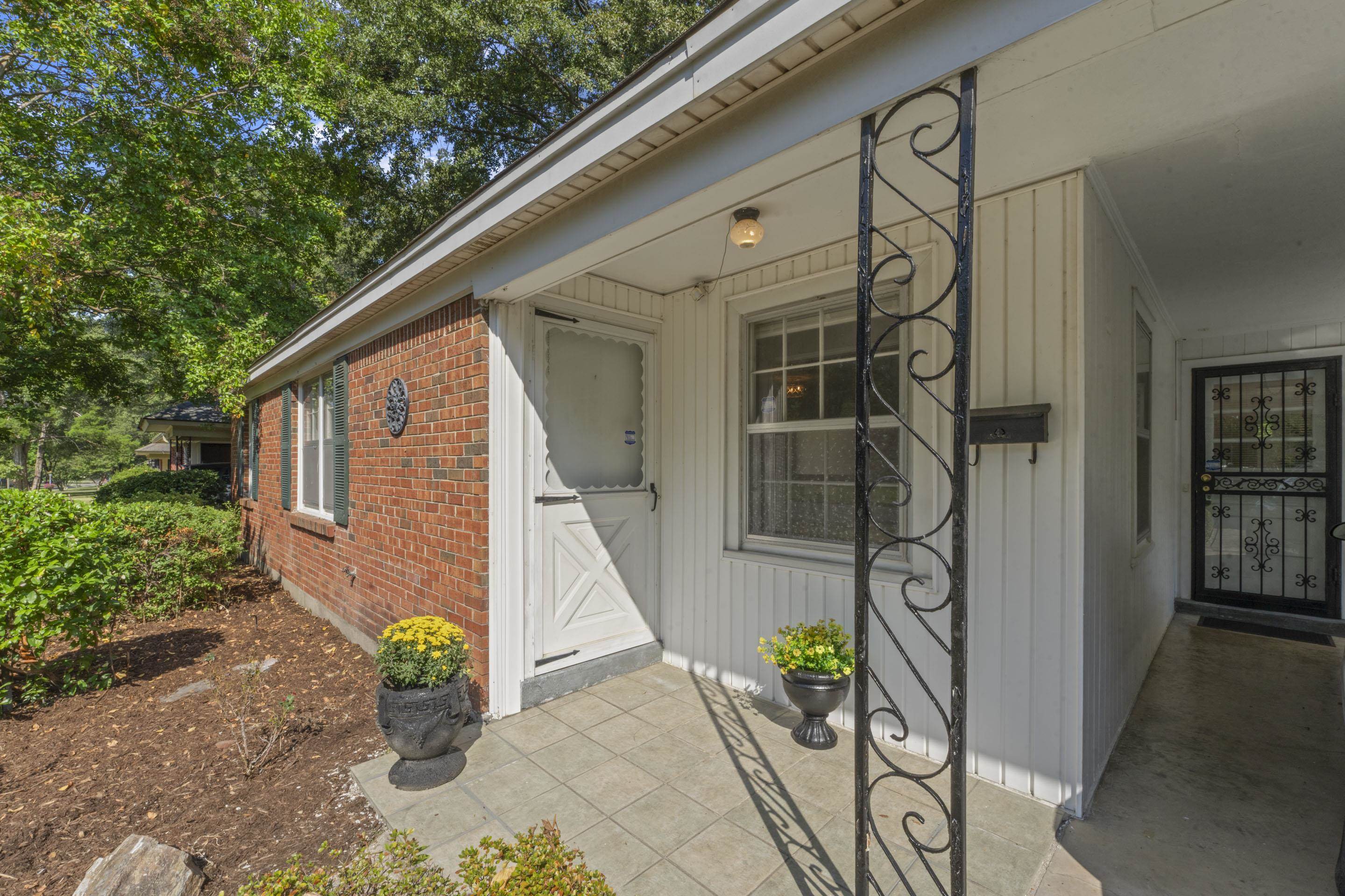 5076 Dee Road Memphis, TN 38117 - Photo 7 of 26 Outside, enjoy a charming front porch and wrought-iron security doors that add style and peace of mind.