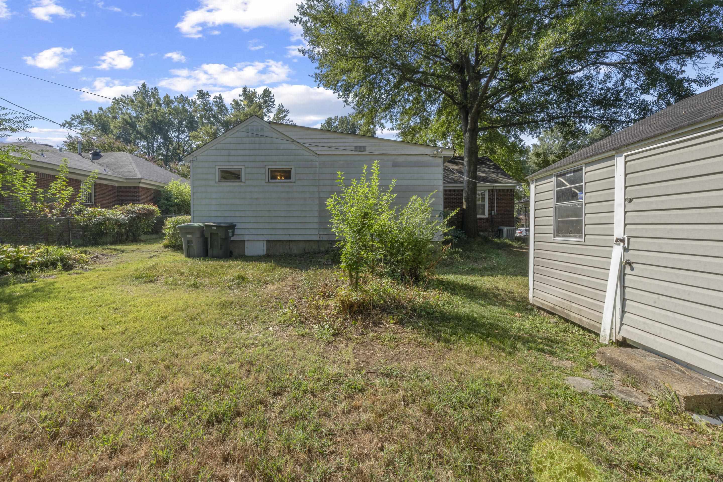 5076 Dee Road Memphis, TN 38117 - Photo 8 of 26 Relax or entertain outdoors in a spacious backyard, perfect for BBQs, gardening, or quiet afternoons under the shade of mature trees.