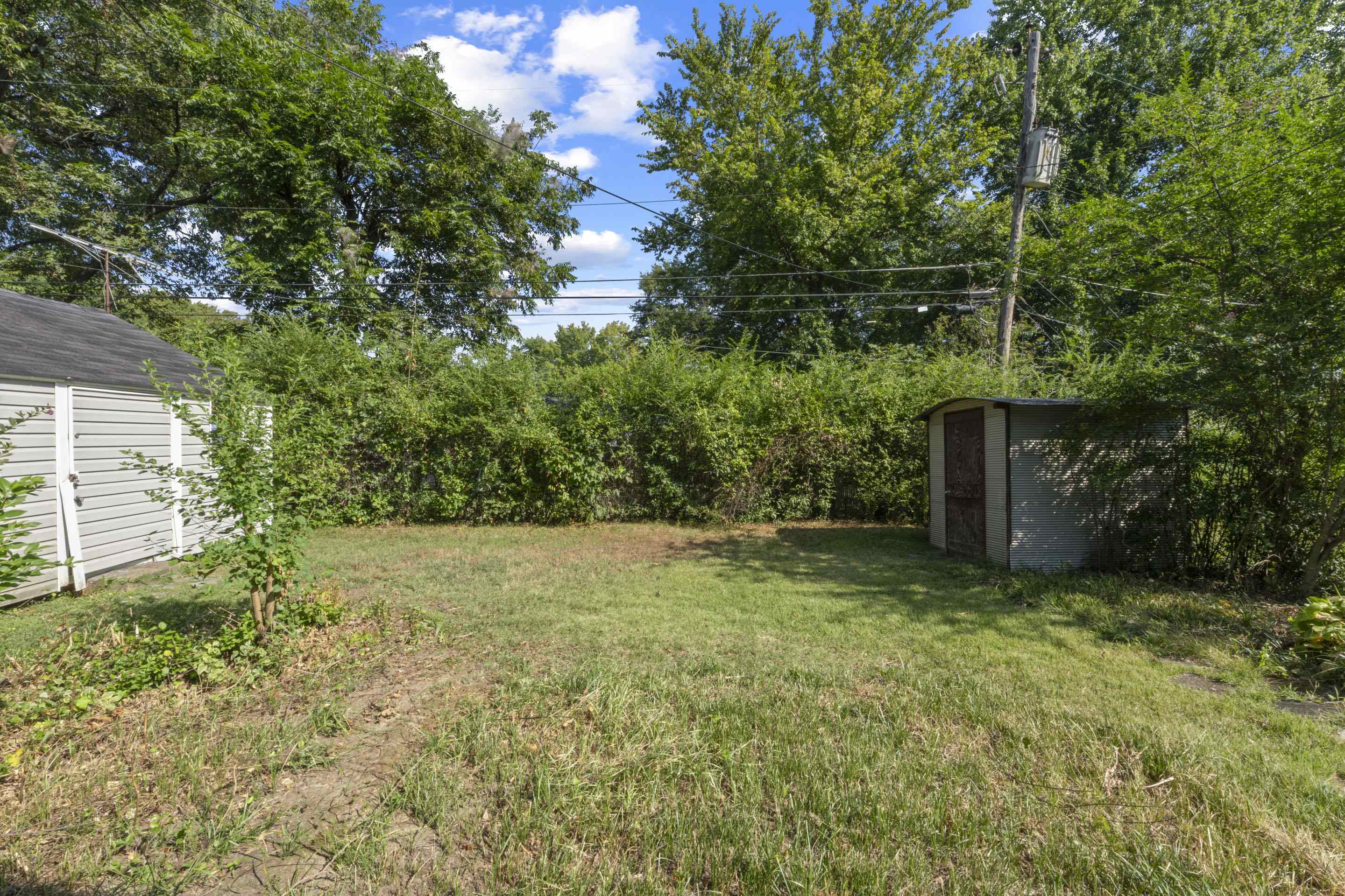 5076 Dee Road Memphis, TN 38117 - Photo 9 of 26 Beyond the lawn, find both a wired workshop and a storage shed — unique additions for hobbies, projects, and keeping everything organized.