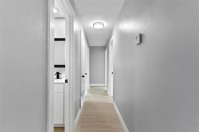a view of a hallway with wooden floor
