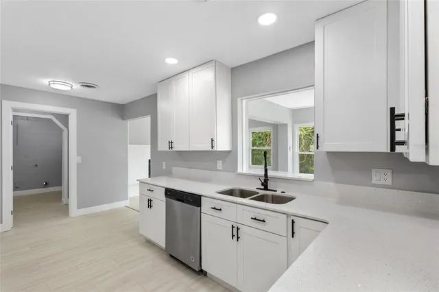 a kitchen with a sink cabinets and window