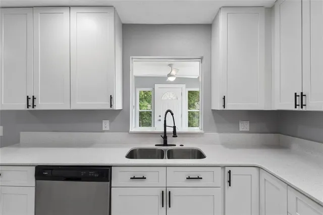 a kitchen with a sink and cabinets