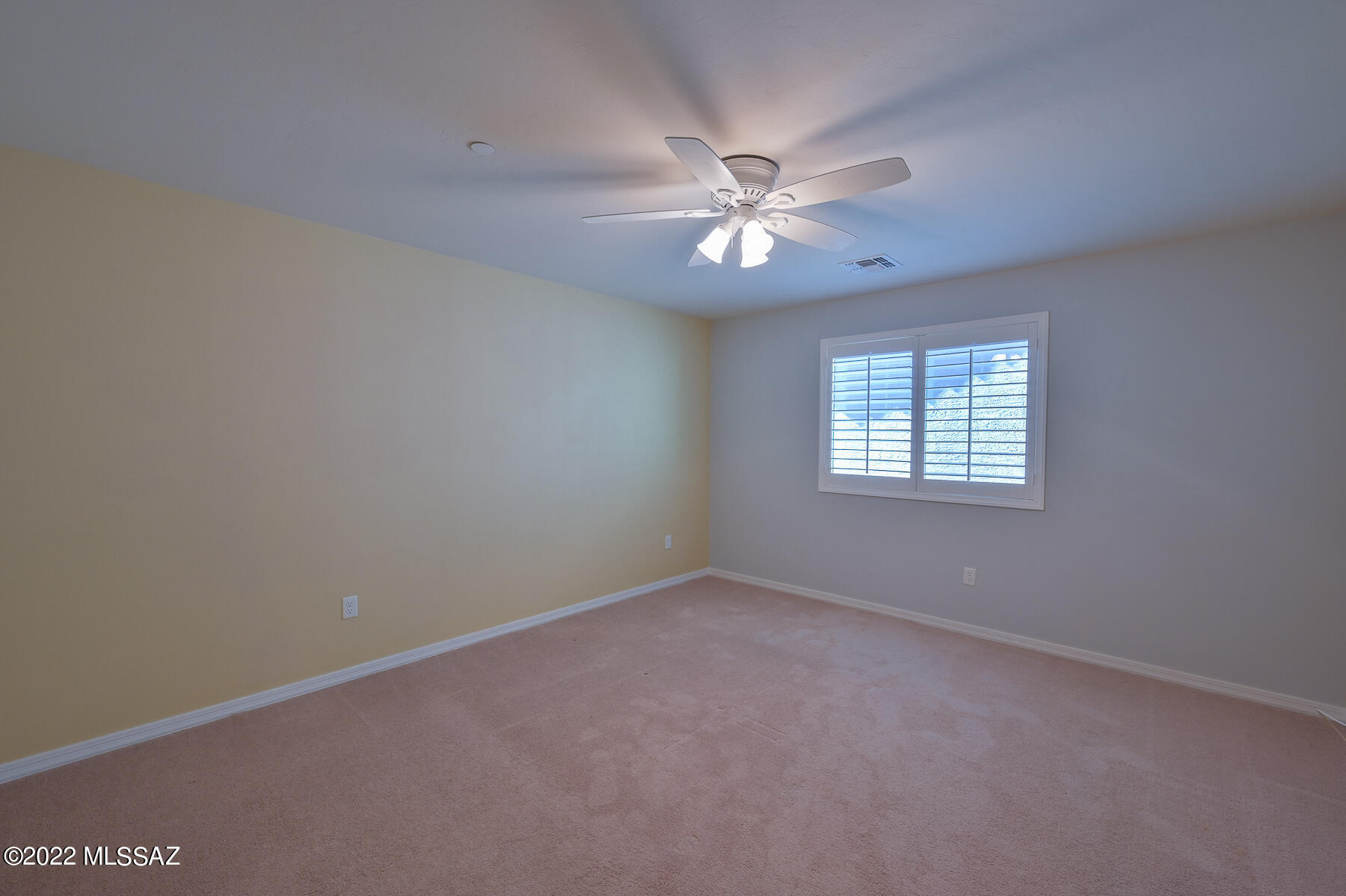 10804 East Salsabila Road Tucson, AZ 85747 - Photo 35 of 50 an empty room with windows and fan