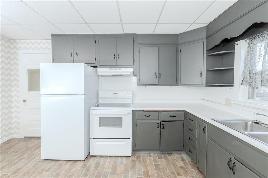 287 Main Street Ernest, PA 15739 - Photo 16 of 26 a kitchen with a sink a refrigerator and cabinets