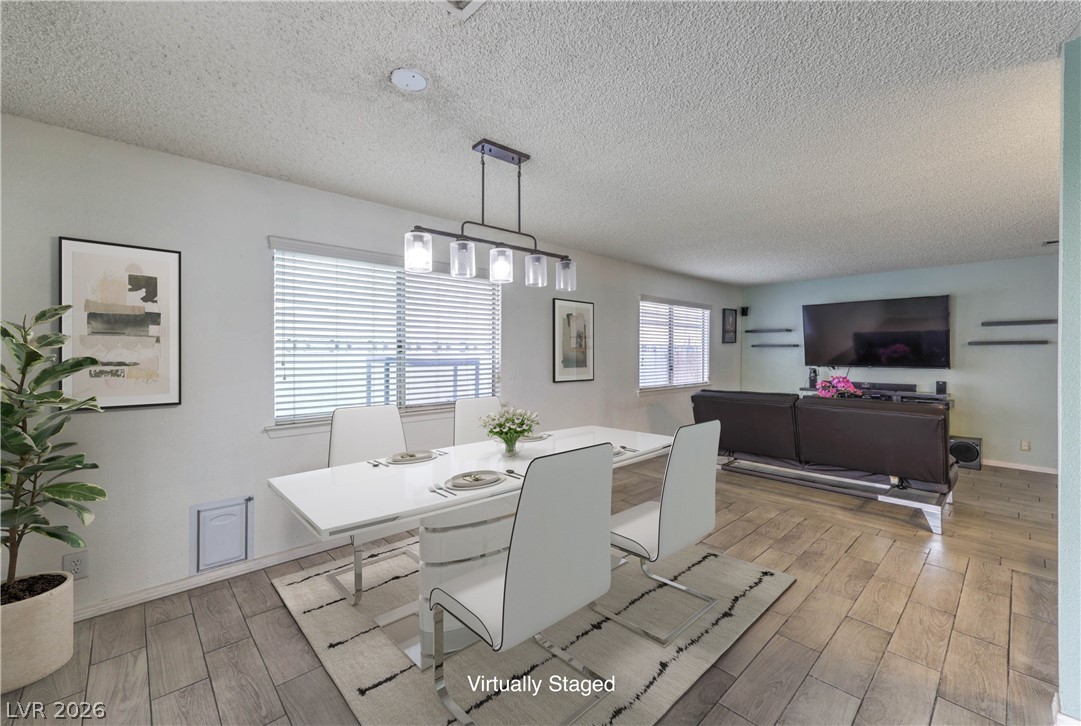 581 Carleton Drive Henderson, NV 89014 - Photo 8 of 37 A refined dining space seamlessly blends into an inviting living area, perfect for entertaining.