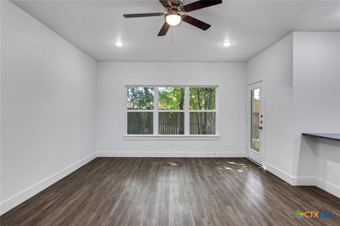 1904 Royal Loop Belton, TX 76513 - Photo 2 of 13 an empty room with wooden floor and windows