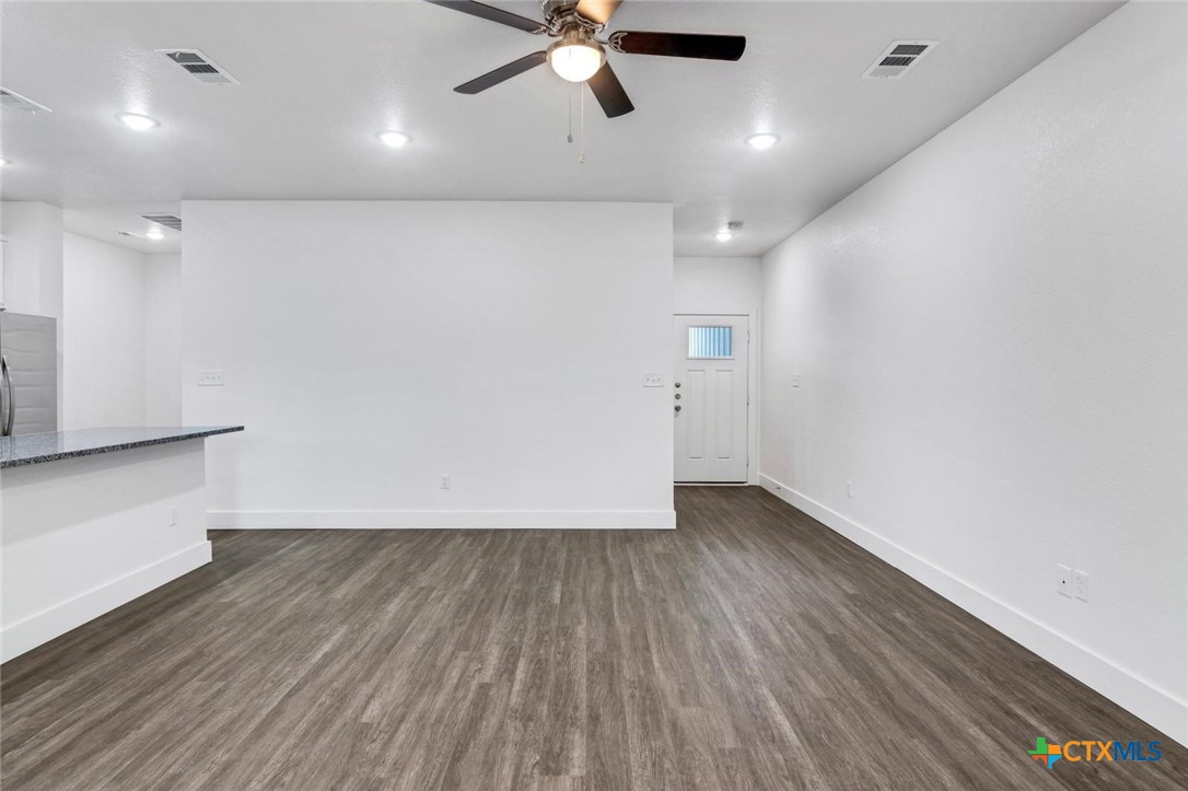 1904 Royal Loop Belton, TX 76513 - Photo 3 of 13 a view of an empty room with wooden floor and a ceiling fan