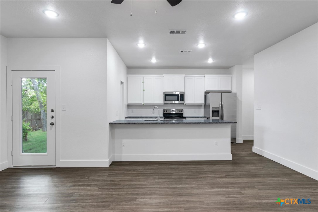1904 Royal Loop Belton, TX 76513 - Photo 4 of 13 a kitchen with stainless steel appliances a refrigerator and a stove top oven