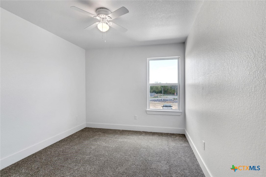 1904 Royal Loop Belton, TX 76513 - Photo 9 of 13 an empty room with a window and a fan