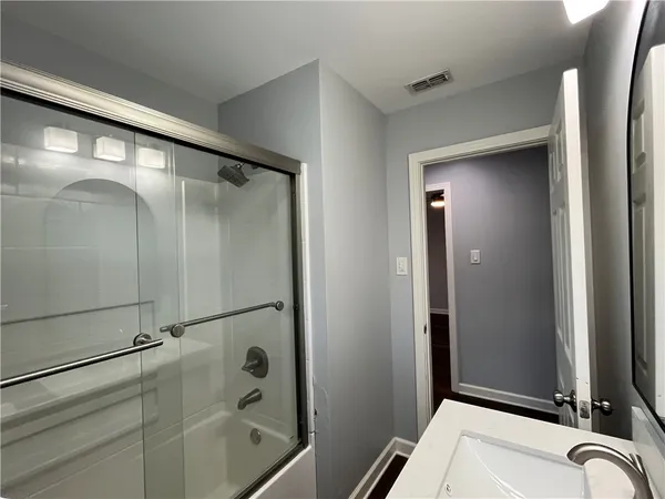 a bathroom with a shower and a mirror