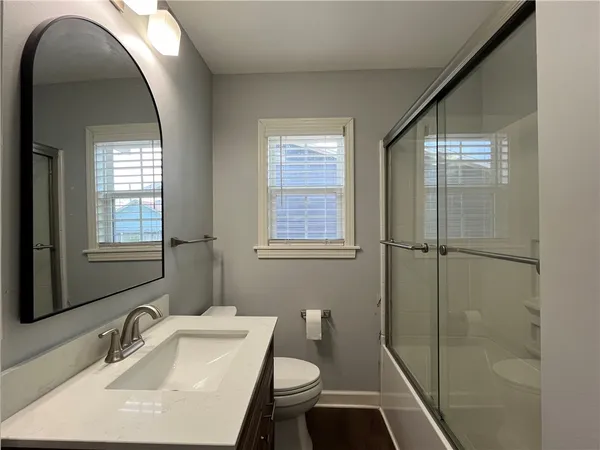 a bathroom with a sink toilet and shower