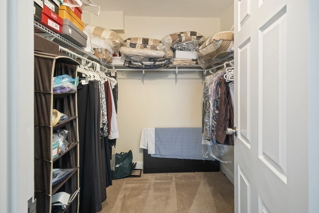 31 Hamlin Lane, Unit B11 Needham, MA 02492 - Photo 11 of 12 a walk in closet with clothes and shoes