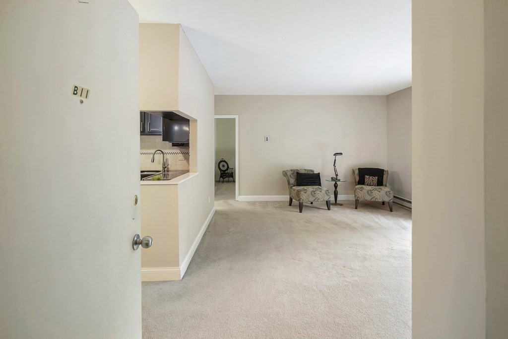 31 Hamlin Lane, Unit B11 Needham, MA 02492 - Photo 2 of 12 a living room with furniture and a flat screen tv