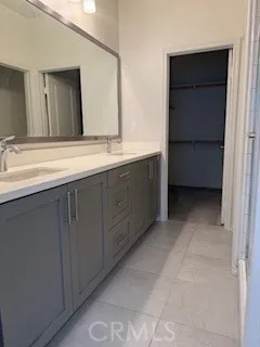 a bathroom with a double vanity sink and mirror