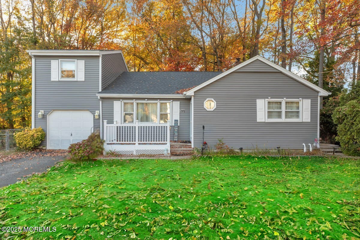a front view of a house with a yard and porch