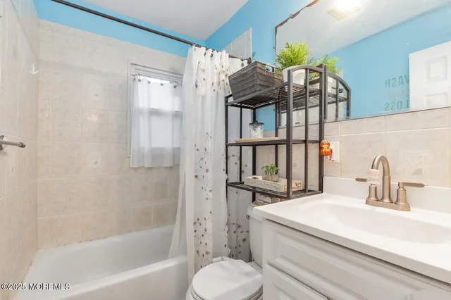 a bedroom with a bed and a dresser in it