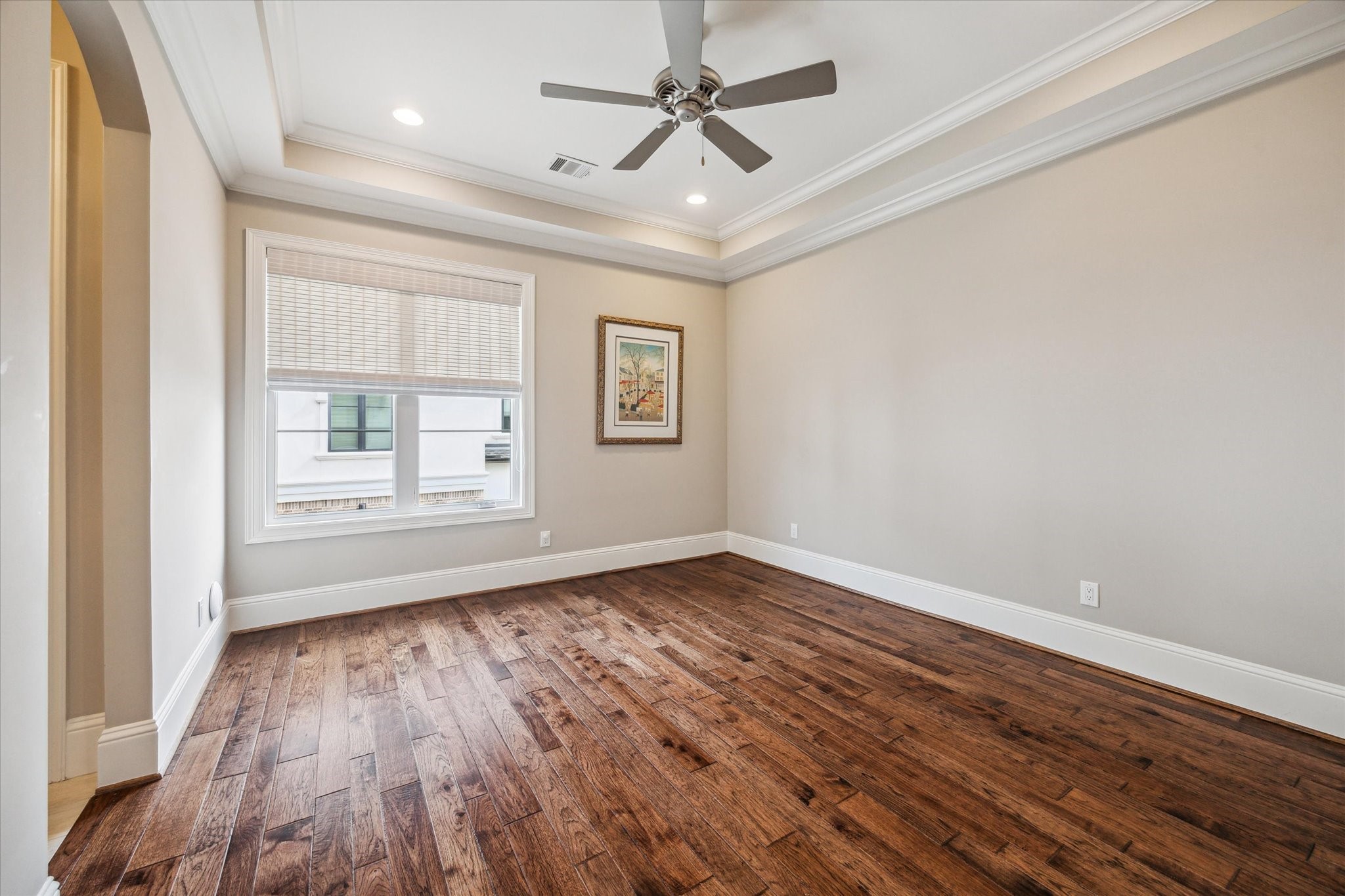 1523 Cunningham Parc Lane Houston, TX 77055 - Photo 15 of 37 an empty room with wooden floor chandelier fan and windows