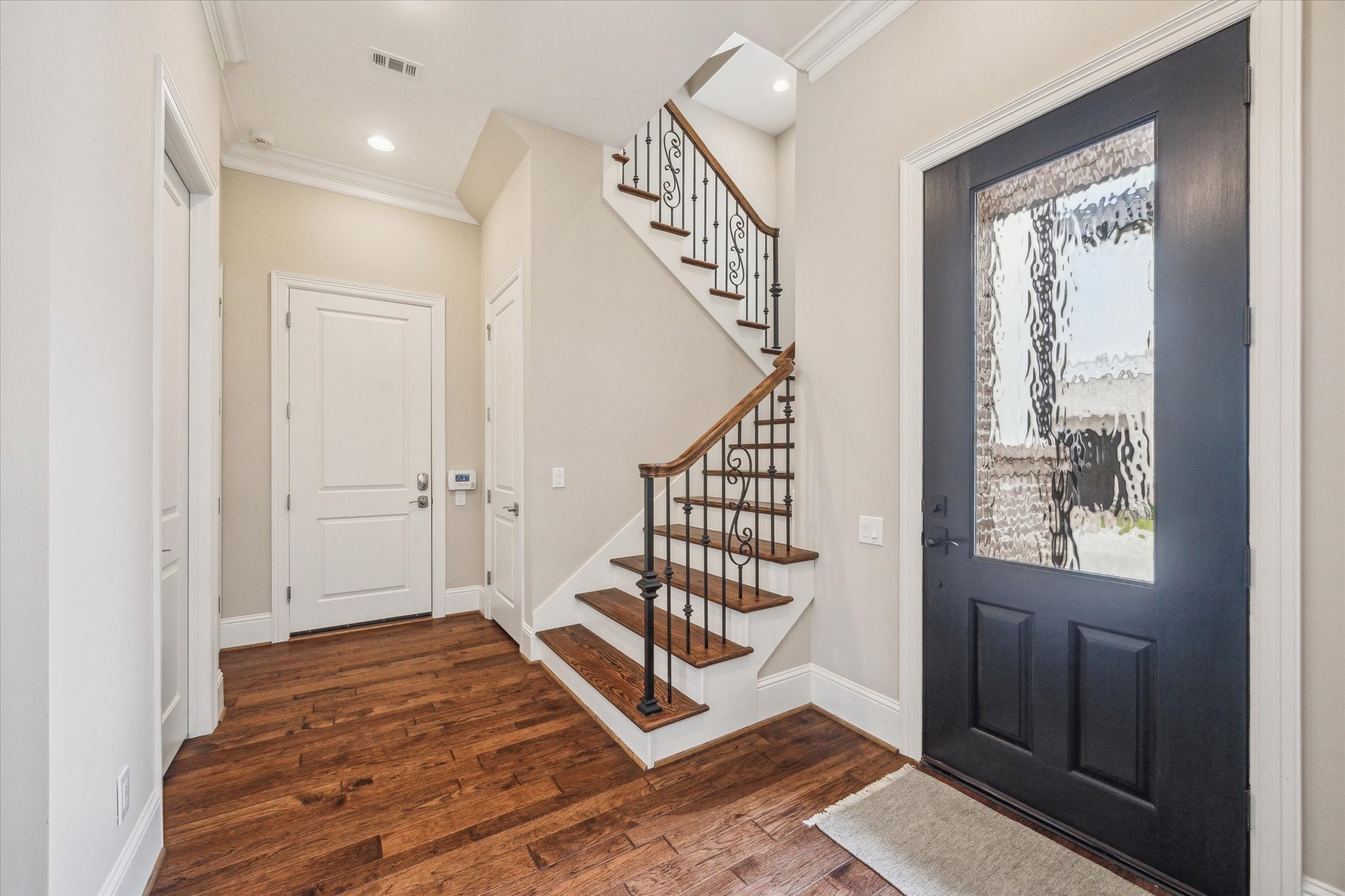1523 Cunningham Parc Lane Houston, TX 77055 - Photo 9 of 37 a view of a hallway with wooden floor and staircase