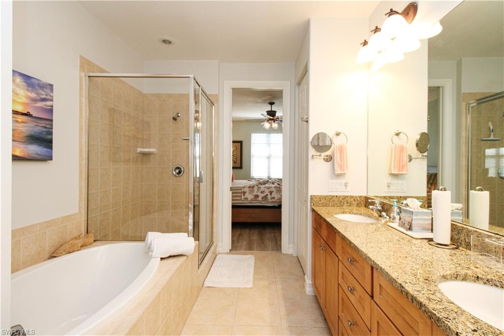 9159 Delano Street, Unit 9905 Naples, FL 34113 - Photo 36 of 44 Bathroom with vanity, separate shower and tub, and tile patterned flooring